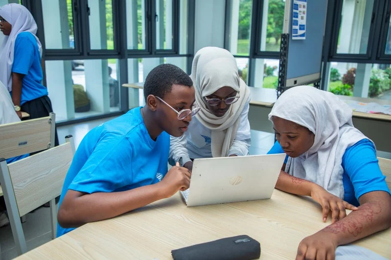 Students coding on a laptop